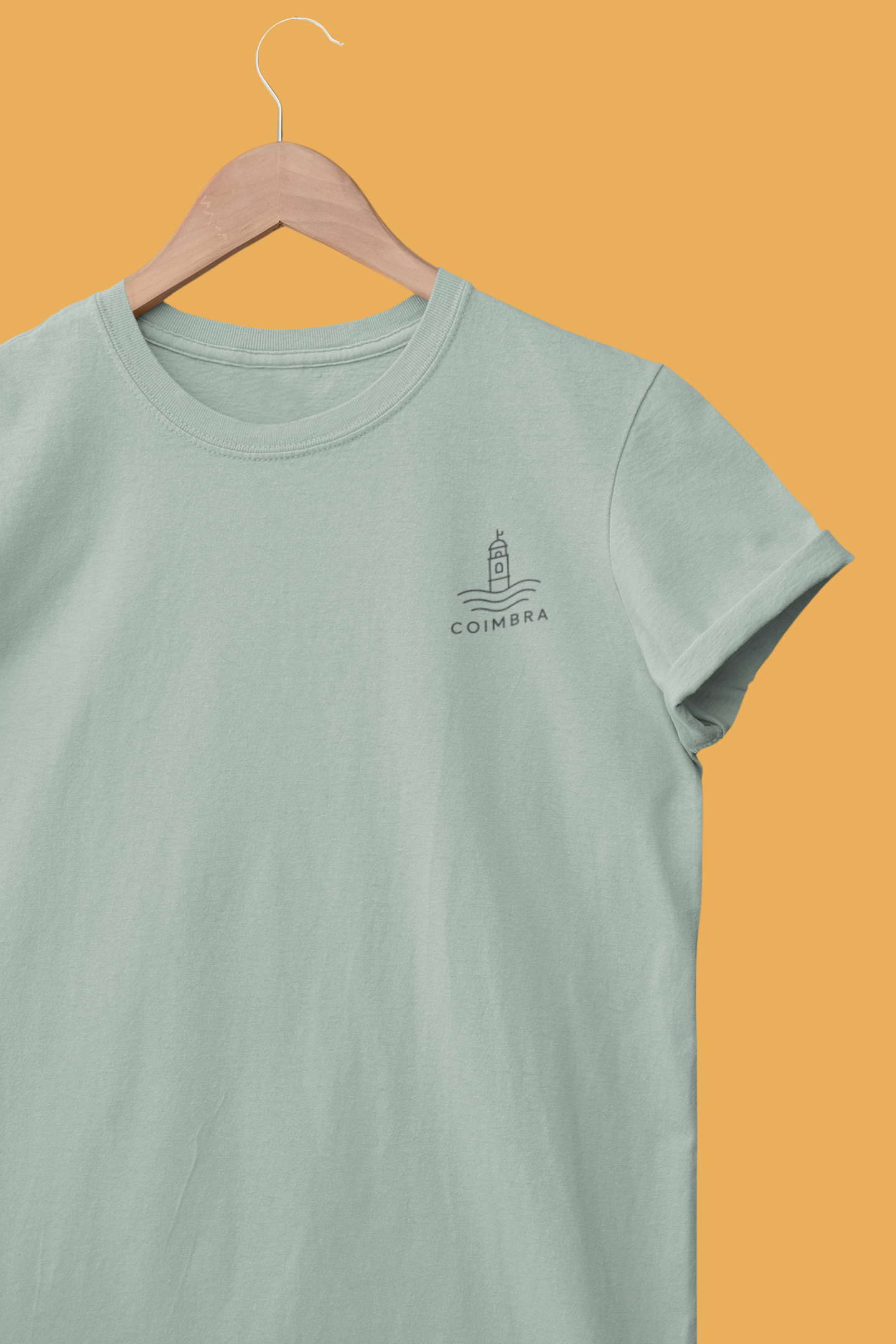 Light blue t-shirt with a logo on a hanger against an orange background