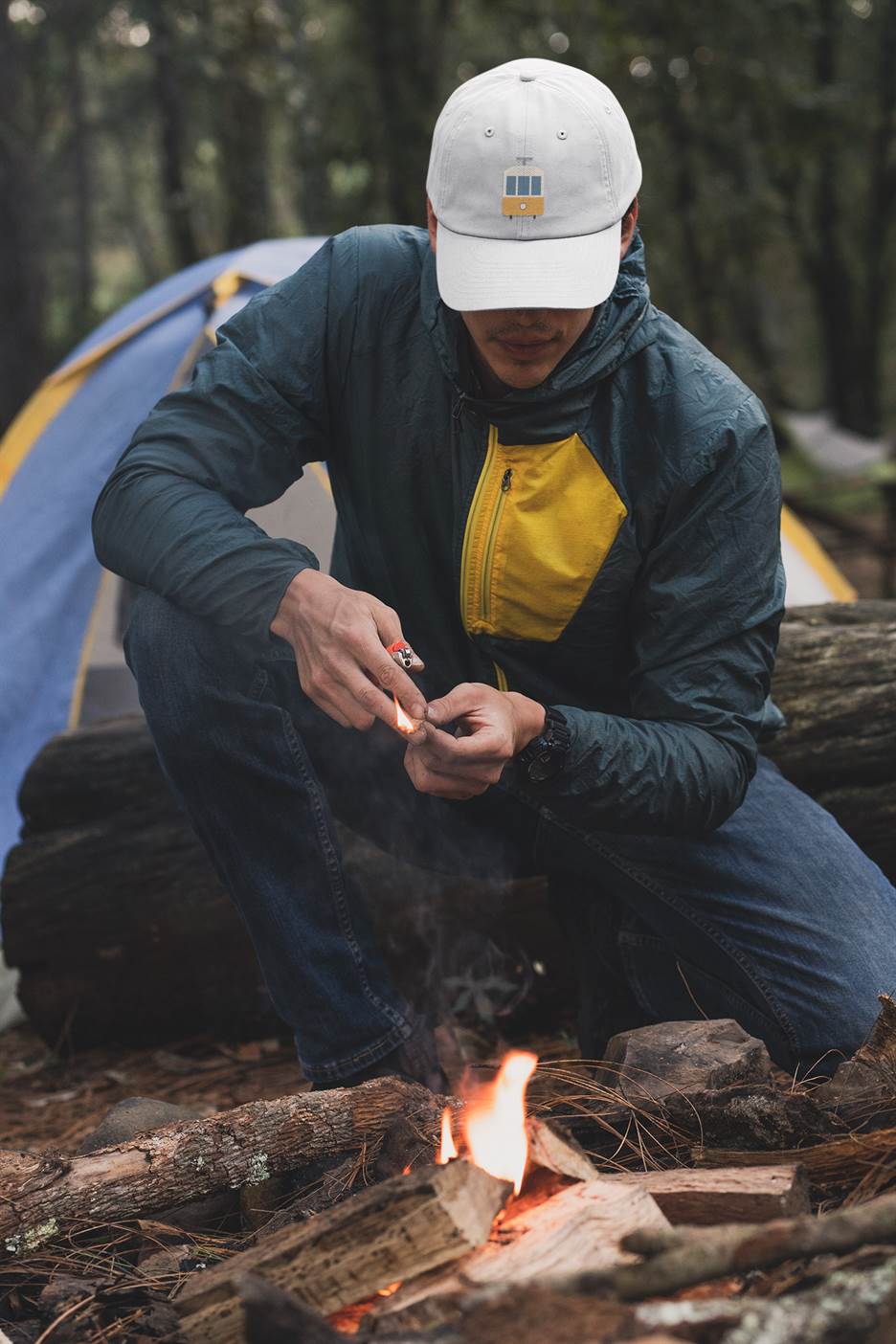 White Lisbon Tram Cap with minimalist embroidery, worn by a man camping. A perfect unisex accessory celebrating Lisbon's iconic tram heritage.