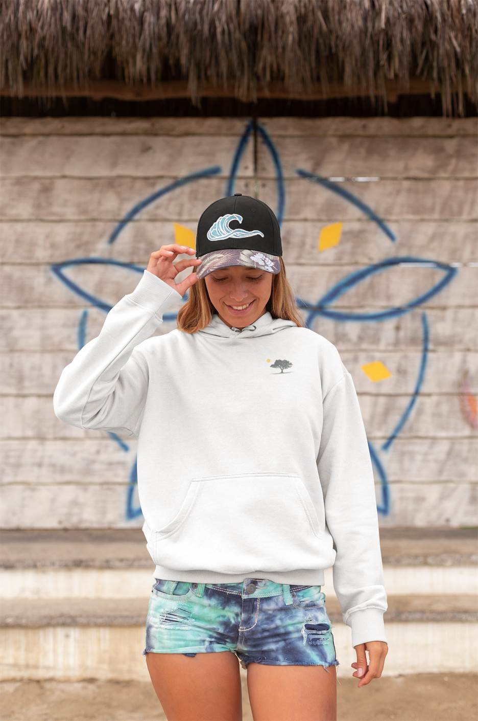 Light gray Evora Sunset Minimal Organic Hoodie paired with denim shorts, offering a relaxed and sustainable fashion choice for outdoor lovers.