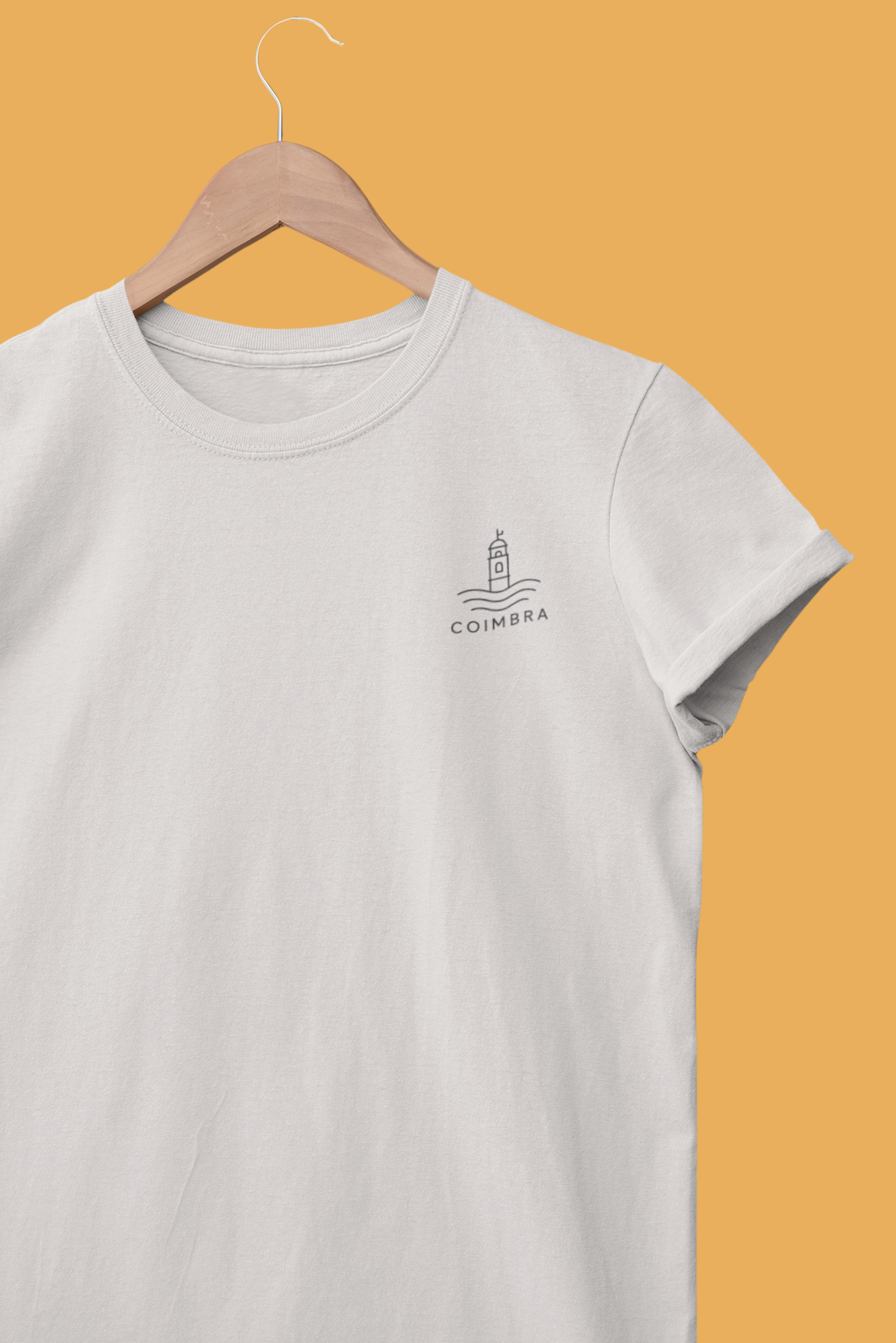 Gray t-shirt with a logo on a hanger against a yellow background
