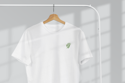 White t-shirt with a green logo on a hanger against a gray background