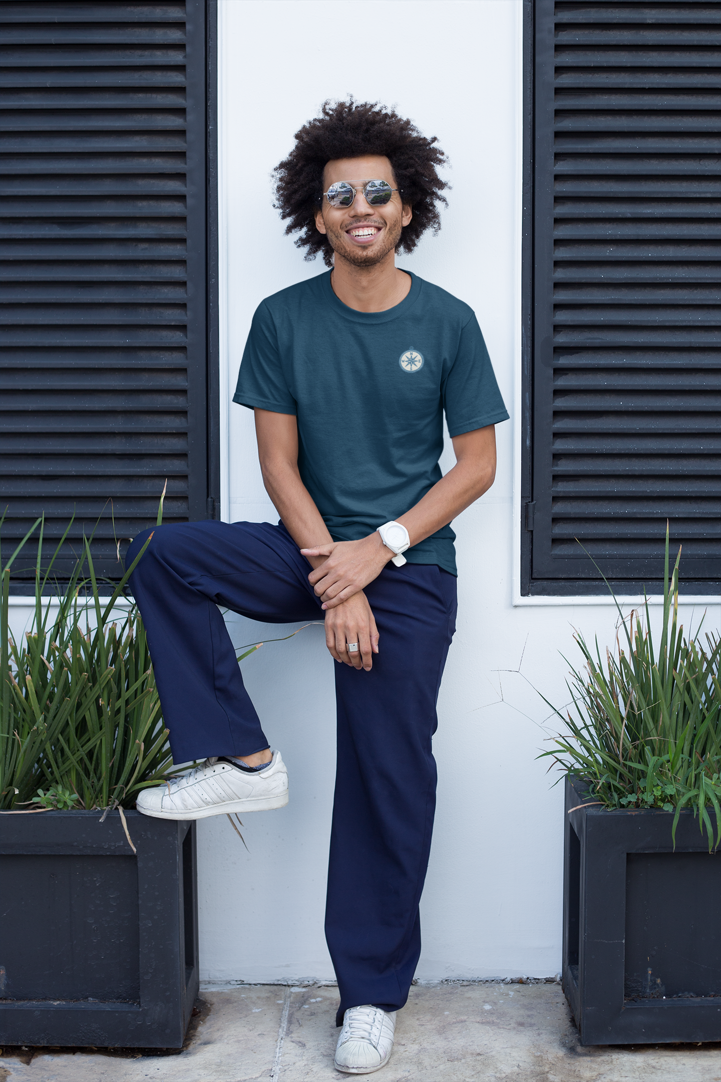 Folded eco-friendly t-shirt with compass line art.