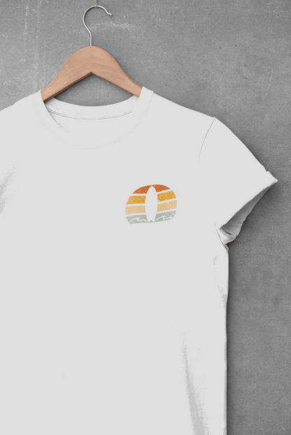 White Nazare Surf Minimal Organic T-shirt with a vintage surf logo, hanging on a wooden hanger against a concrete wall. Made from 100% organic cotton.