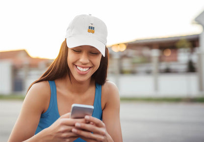 Minimalist Lisbon Tram Cap in white, worn by a smiling woman outdoors. A stylish and unisex tribute to Lisbon's historic tram culture.