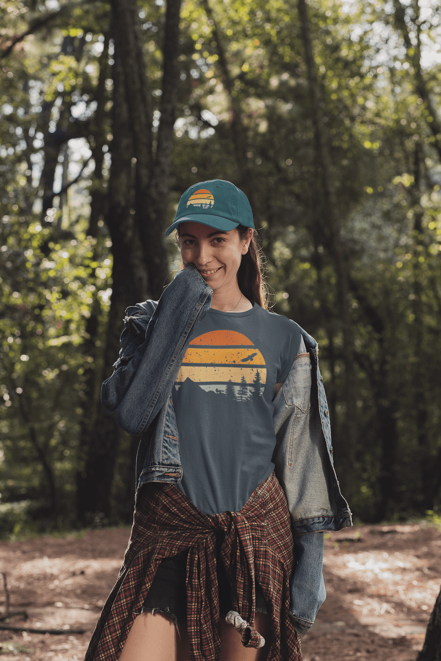 Green Madeira Vintage Cap with a mountain logo, worn by a woman in a forest. A perfect blend of adventure and style.