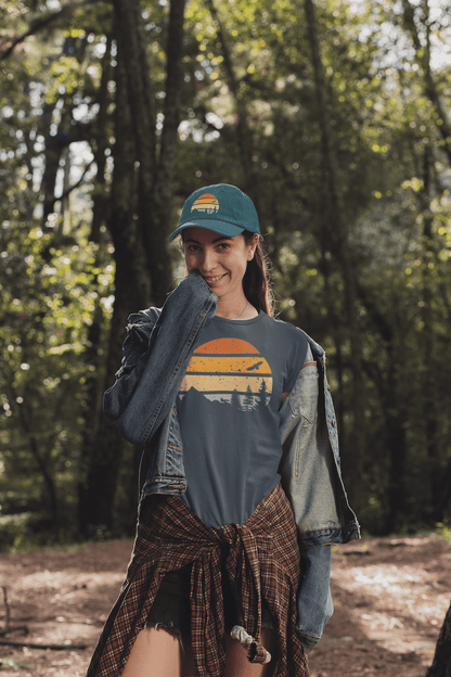 Green Madeira Vintage Cap with a mountain logo, worn by a woman in a forest. A perfect blend of adventure and style.