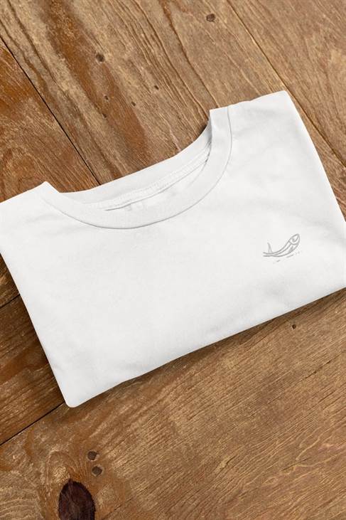Folded white sardine t-shirt with minimalist embroidered fish design on a wooden surface. Crafted from organic cotton for an eco-friendly and stylish fit.