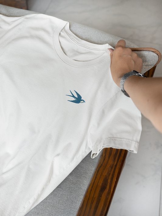 White sustainable shirt featuring minimal swallow line art.