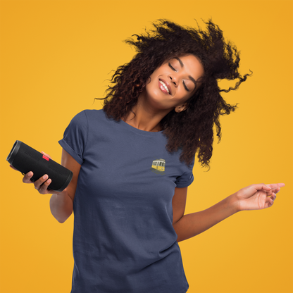 Woman holding a black speaker against a yellow background