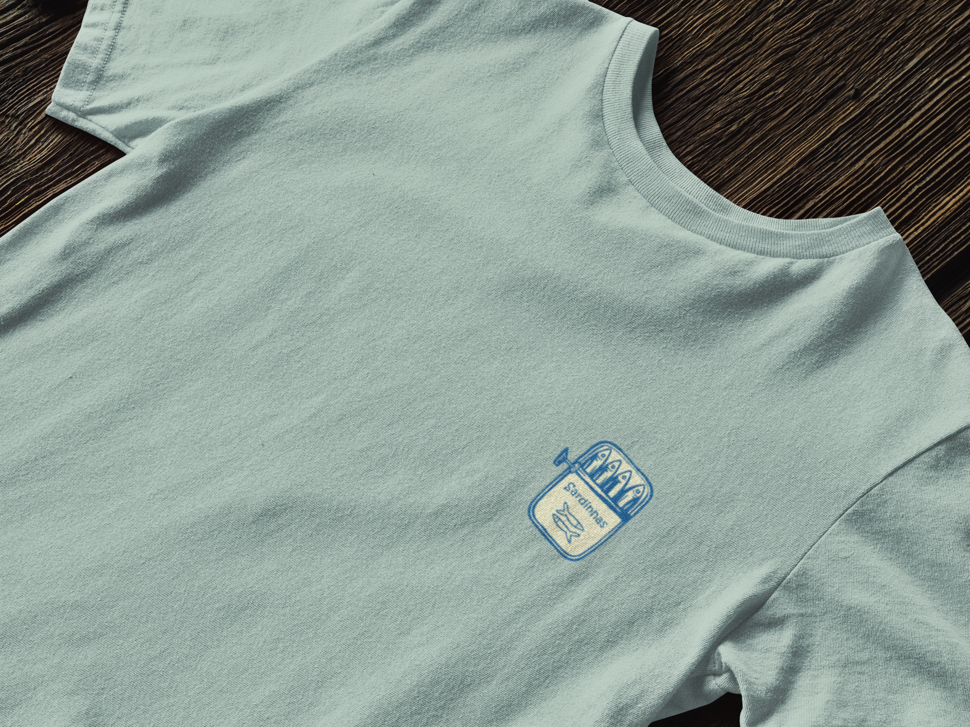 Folded eco-friendly t-shirt with sardine can symbol.