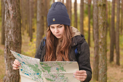 Navy blue Lisbon Electrico Beanie worn during an outdoor adventure. A cozy and stylish embroidered hat inspired by Lisbon's heritage.